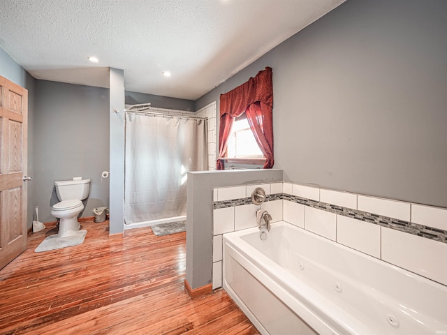 bathroom featuring wood-type flooring, a textured ceiling, toilet, and plus walk in shower