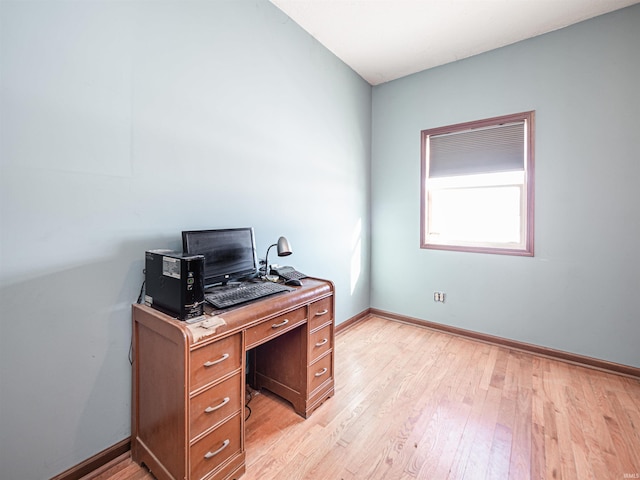 home office with light hardwood / wood-style floors