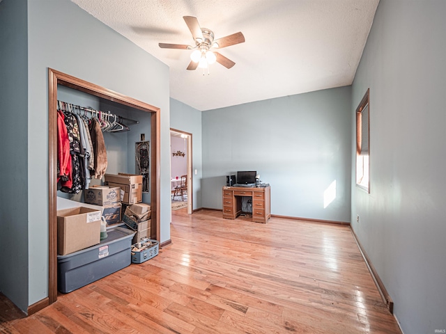 interior space with ceiling fan, light wood-type flooring, and a textured ceiling