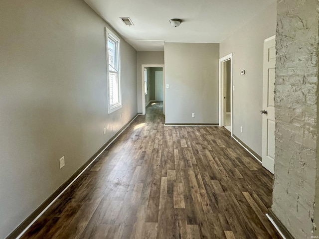 spare room featuring dark wood-type flooring