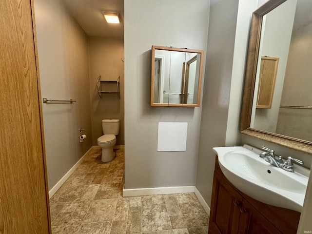 bathroom with toilet and vanity