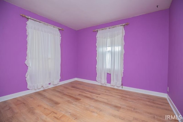 unfurnished room with light wood-type flooring