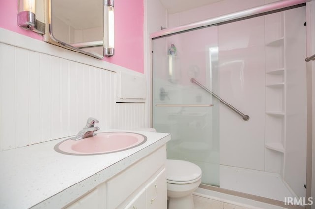 bathroom with toilet, walk in shower, and vanity