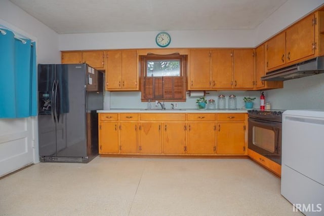 kitchen featuring black appliances, washer / clothes dryer, and sink