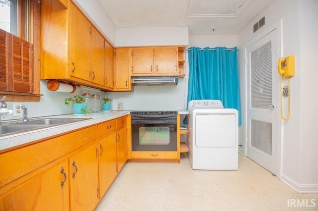 kitchen with black electric range oven, washer / dryer, sink, and oven