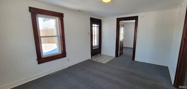 empty room with dark colored carpet