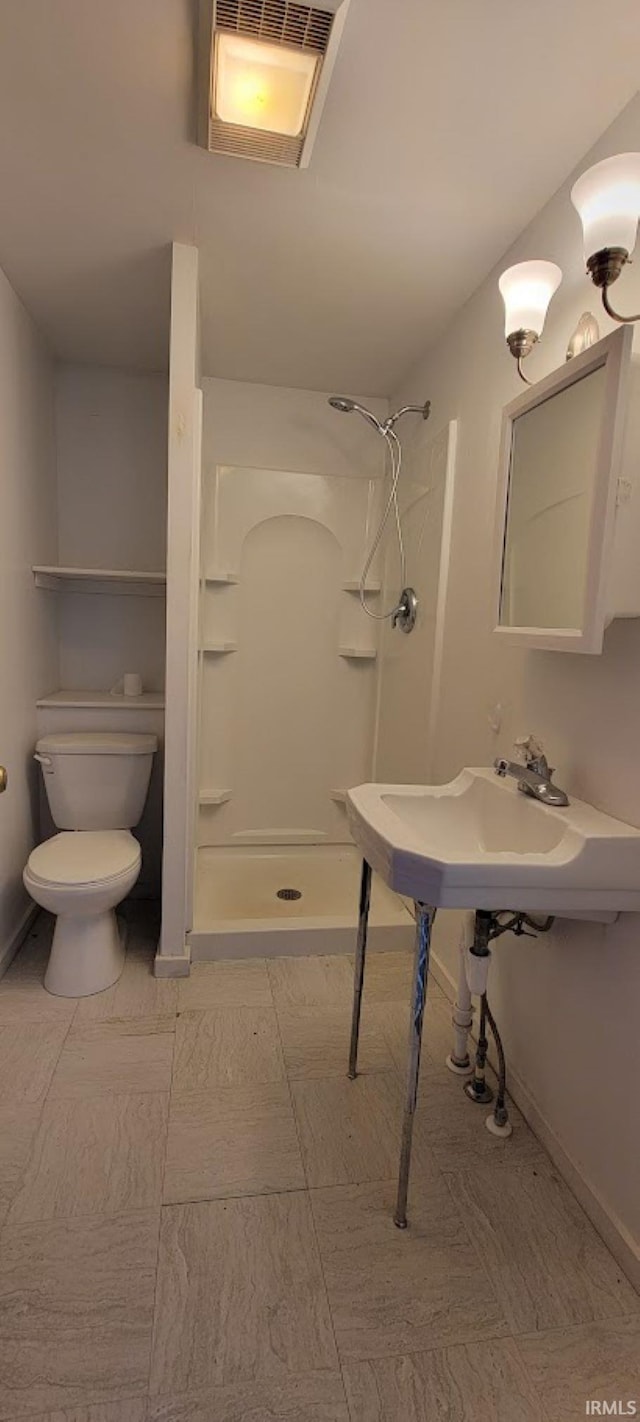 bathroom with walk in shower and toilet