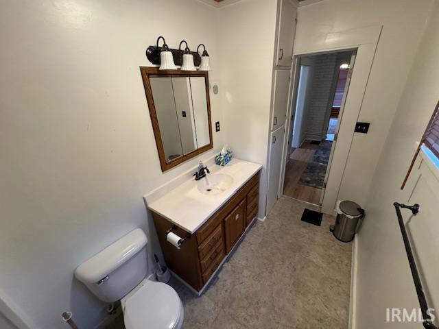 bathroom featuring toilet and vanity