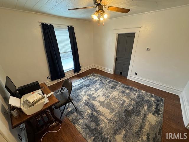 office space featuring ceiling fan, dark hardwood / wood-style flooring, and ornamental molding