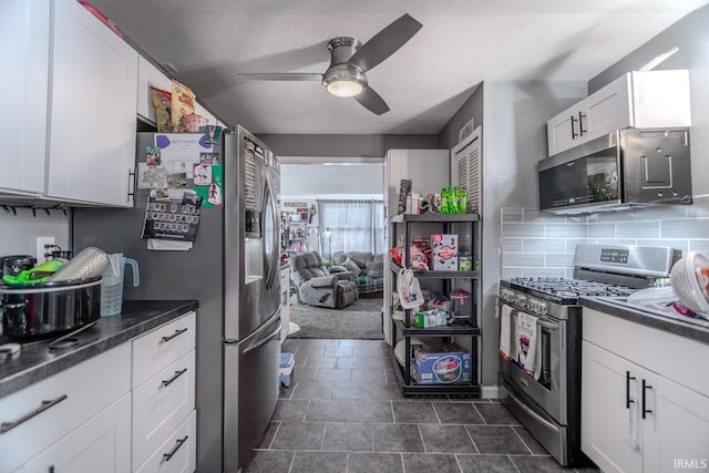 kitchen featuring ceiling fan, stainless steel appliances, decorative backsplash, and white cabinets