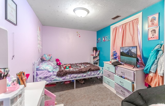 bedroom with a textured ceiling and carpet