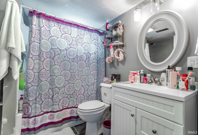 bathroom featuring toilet, tile patterned flooring, and vanity