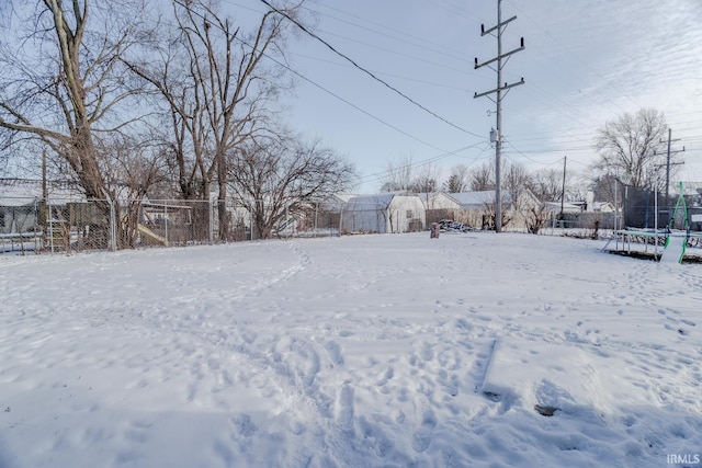 snowy yard with a trampoline