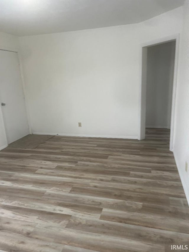 unfurnished room with hardwood / wood-style flooring