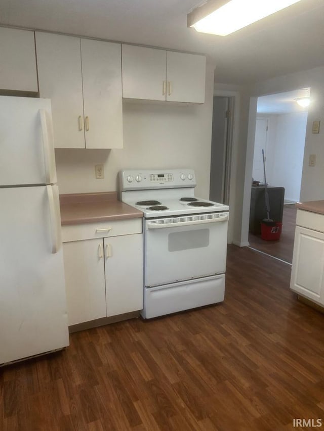 kitchen with dark wood-type flooring, white appliances, and white cabinets