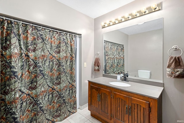 bathroom featuring toilet, a textured ceiling, tile patterned floors, and vanity