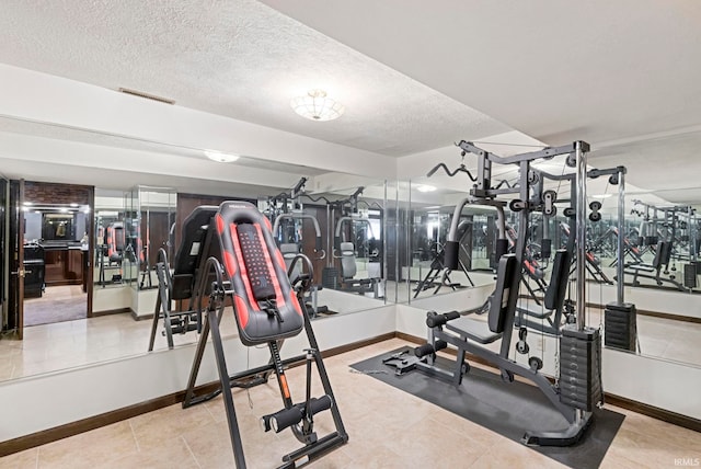 exercise room featuring a textured ceiling