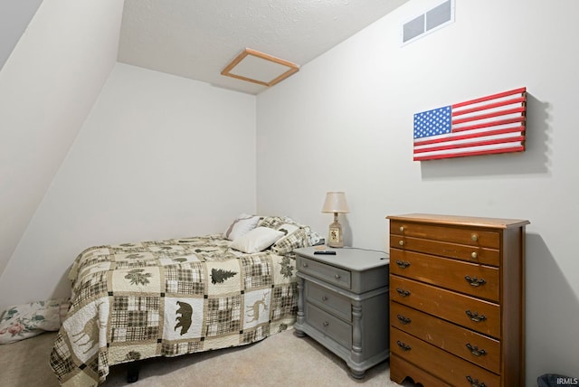 carpeted bedroom featuring a textured ceiling