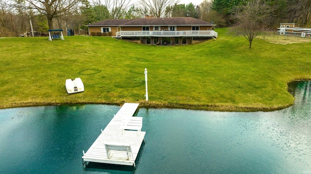 dock area with a yard and a water view