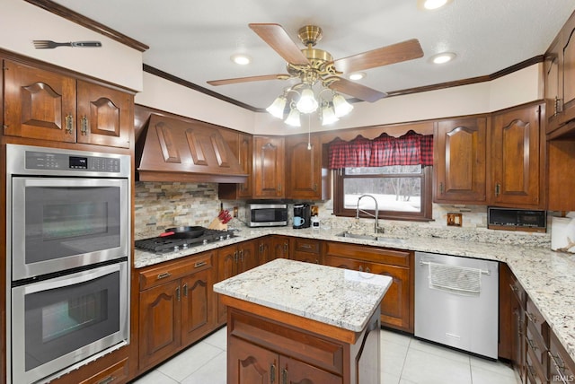 kitchen with light stone countertops, a center island, stainless steel appliances, sink, and custom range hood