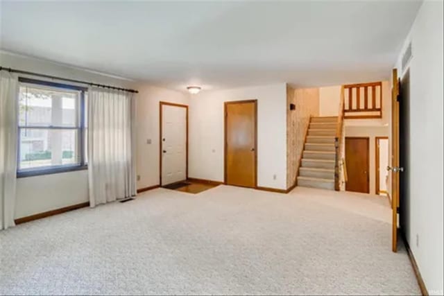 spare room with light colored carpet