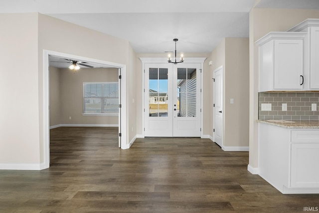 entrance foyer featuring dark hardwood / wood-style floors and ceiling fan with notable chandelier