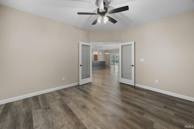 unfurnished room featuring dark hardwood / wood-style floors, ceiling fan, and french doors