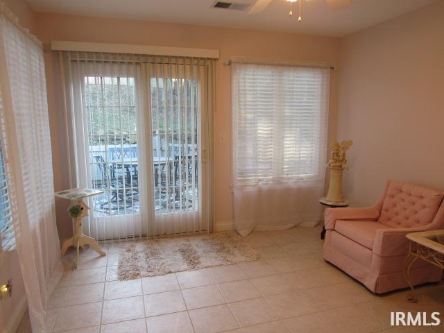 sitting room featuring ceiling fan and light tile patterned floors