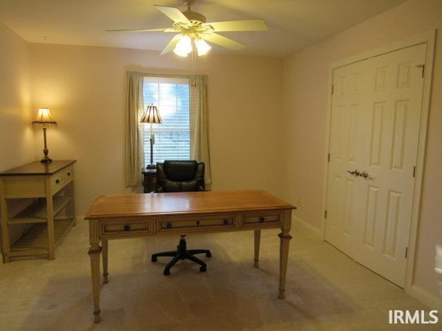 office space with ceiling fan and light colored carpet