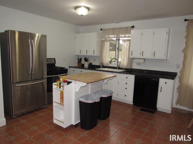 kitchen featuring white cabinets, appliances with stainless steel finishes, and sink