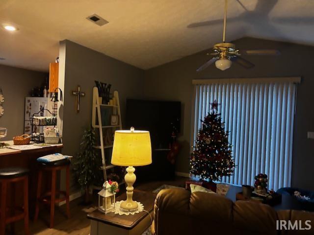 living room with ceiling fan and vaulted ceiling