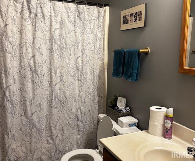 bathroom featuring toilet and vanity