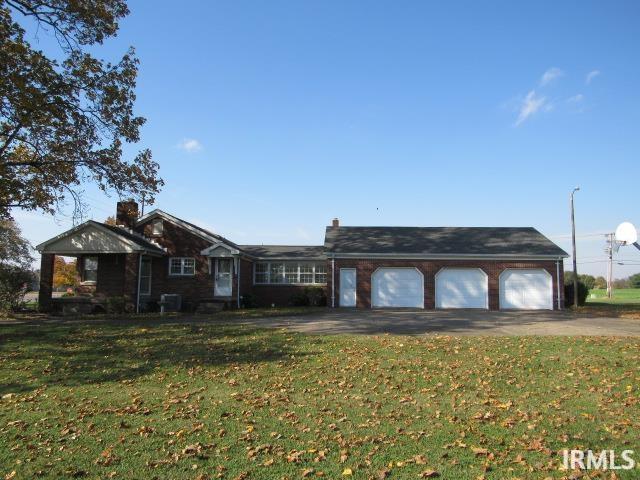 ranch-style house with a front yard and a garage