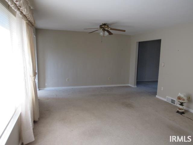 spare room with light carpet and ceiling fan