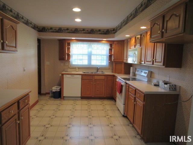 kitchen with sink and white appliances