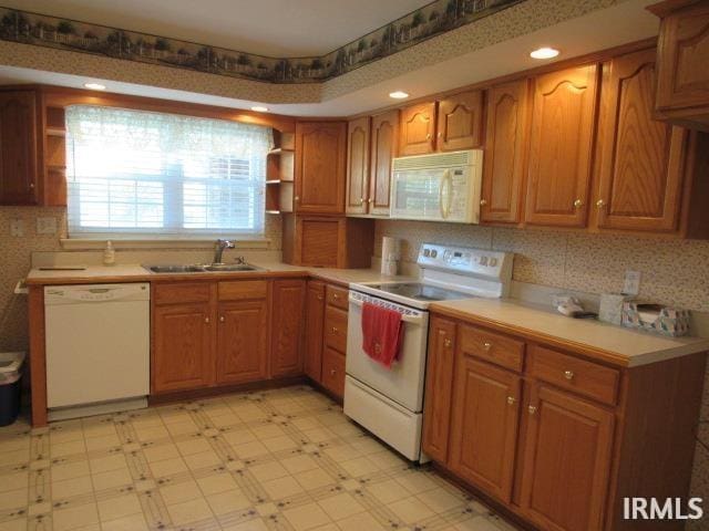 kitchen with sink and white appliances