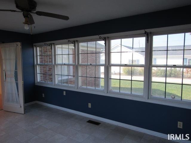 unfurnished room with ceiling fan