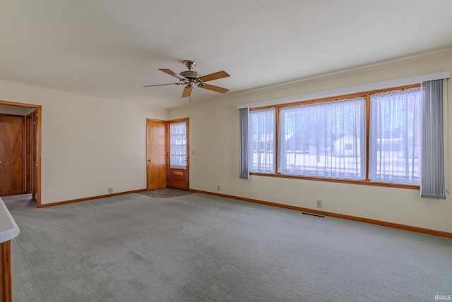 empty room featuring light carpet and ceiling fan