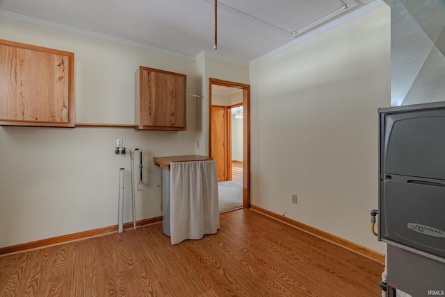 washroom with light hardwood / wood-style flooring and ornamental molding