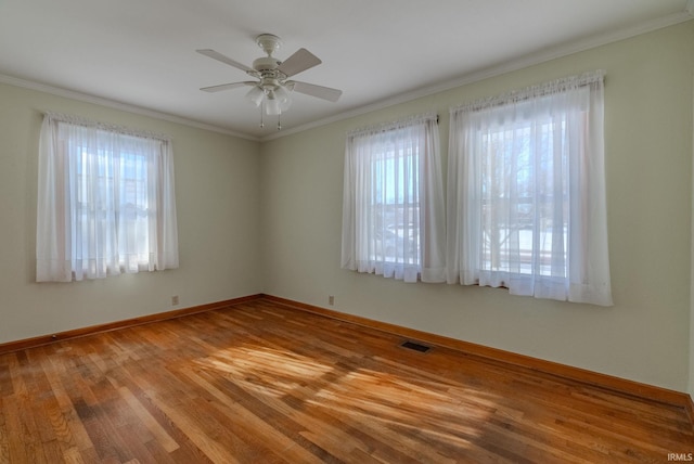 unfurnished room featuring ceiling fan, light hardwood / wood-style floors, and ornamental molding