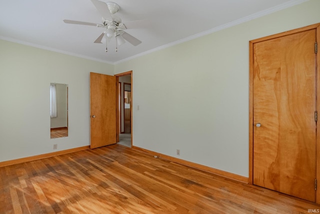 empty room featuring ceiling fan, crown molding, and light hardwood / wood-style floors