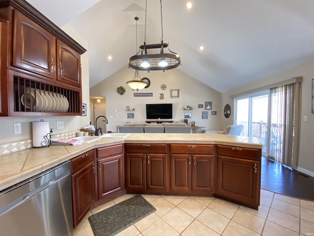 kitchen featuring dishwasher, tile counters, decorative light fixtures, sink, and light tile patterned flooring