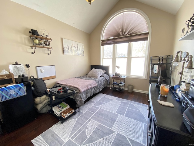 bedroom featuring dark wood-type flooring and lofted ceiling