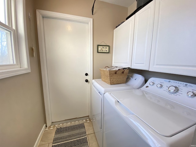 laundry area with cabinets, light tile patterned flooring, and washing machine and clothes dryer