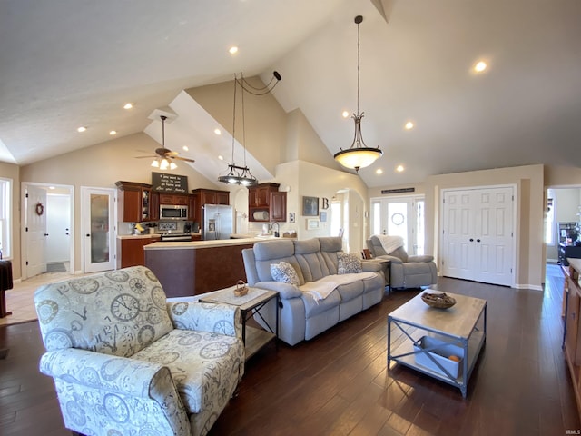 living room with high vaulted ceiling, ceiling fan, and dark hardwood / wood-style floors