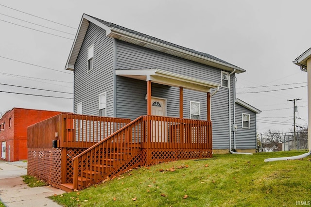 exterior space with a wooden deck and a lawn