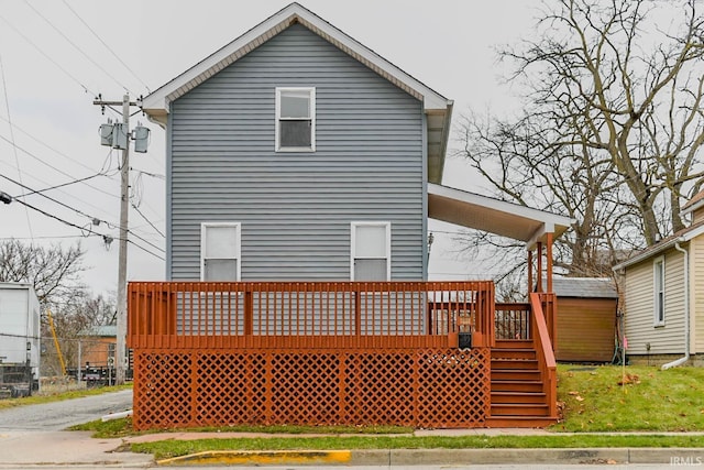 rear view of property with a wooden deck