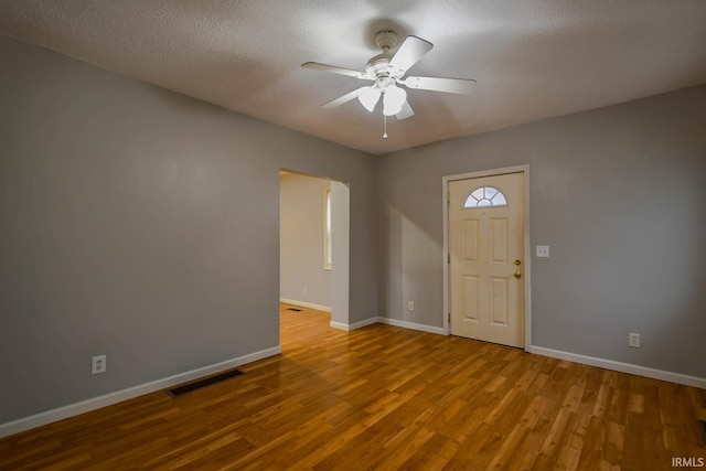 entryway featuring light hardwood / wood-style floors, a textured ceiling, and ceiling fan