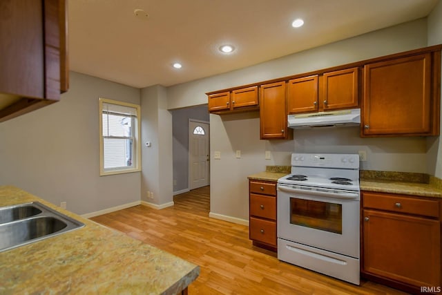 kitchen featuring white electric stove, light hardwood / wood-style flooring, and sink