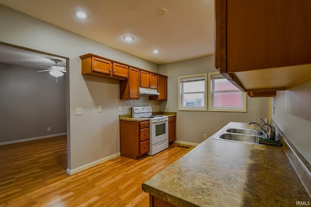 kitchen featuring ceiling fan, sink, white electric stove, and light wood-type flooring